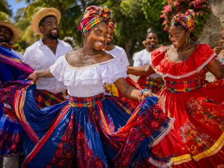 Dancers in traditional Haitian dress performing outdoors